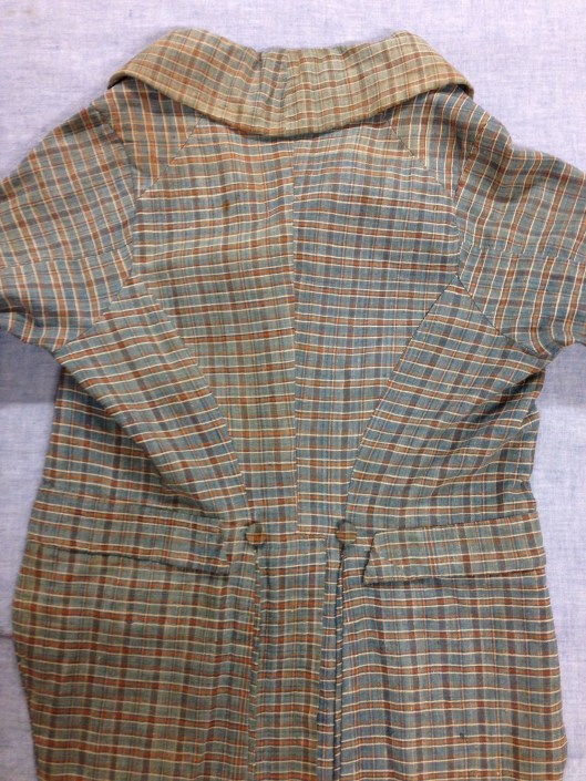 1967.13.17, back view of "Stonington Plaid" checked linen coat. Gift of Mrs Muriel Buckley, URI Textiles Collection.
