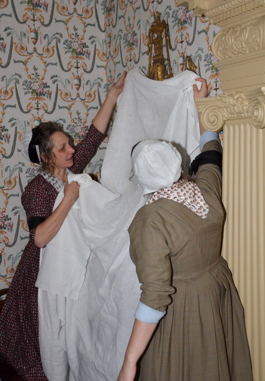 Esther and Kitty draping the mirrors