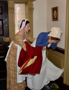 Mary assists Alice in the hallway as she prepares to face her mother. Photograph by J. D. Kay
