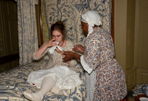 Goody Morris helps Alice drink lemon water to soothe her stomach. Photograph by J. D. Kay